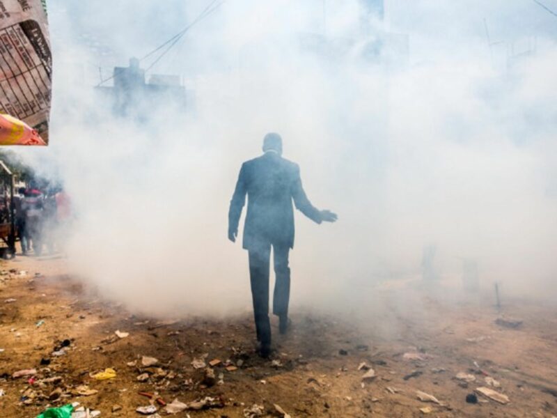 A man walks through a cloud of disinfectant smoke at the Grand Dakar market in Senegal.