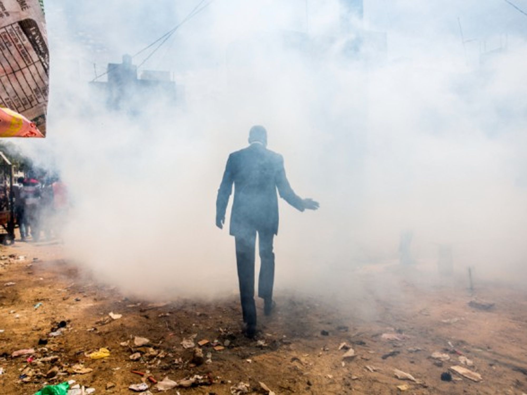 A man walks through a cloud of disinfectant smoke at the Grand Dakar market in Senegal.