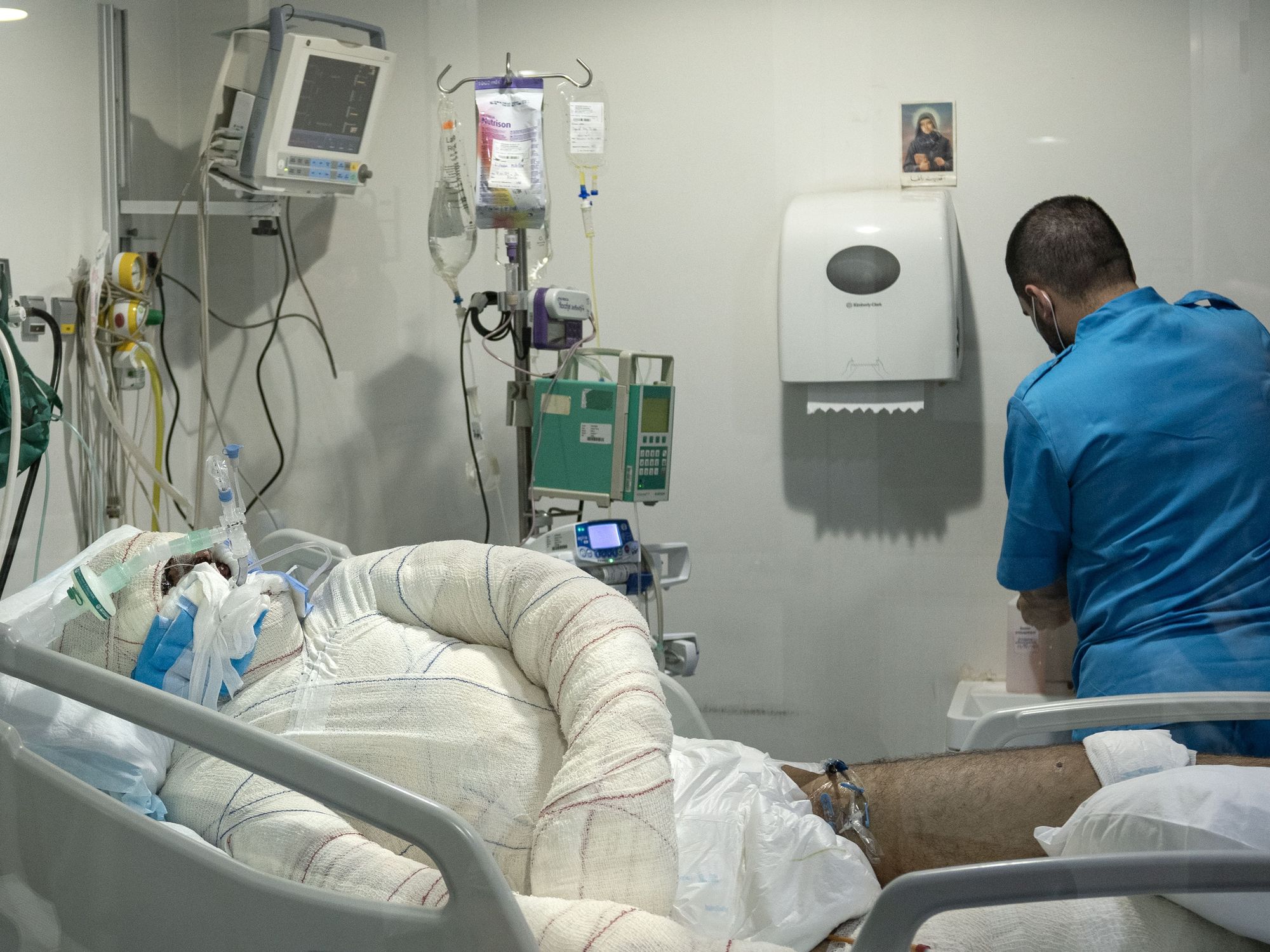 A man whose body was 50 per cent burned seen laying unconscious on a bed in the burns unit of Lebanon's Geitawi hospital.