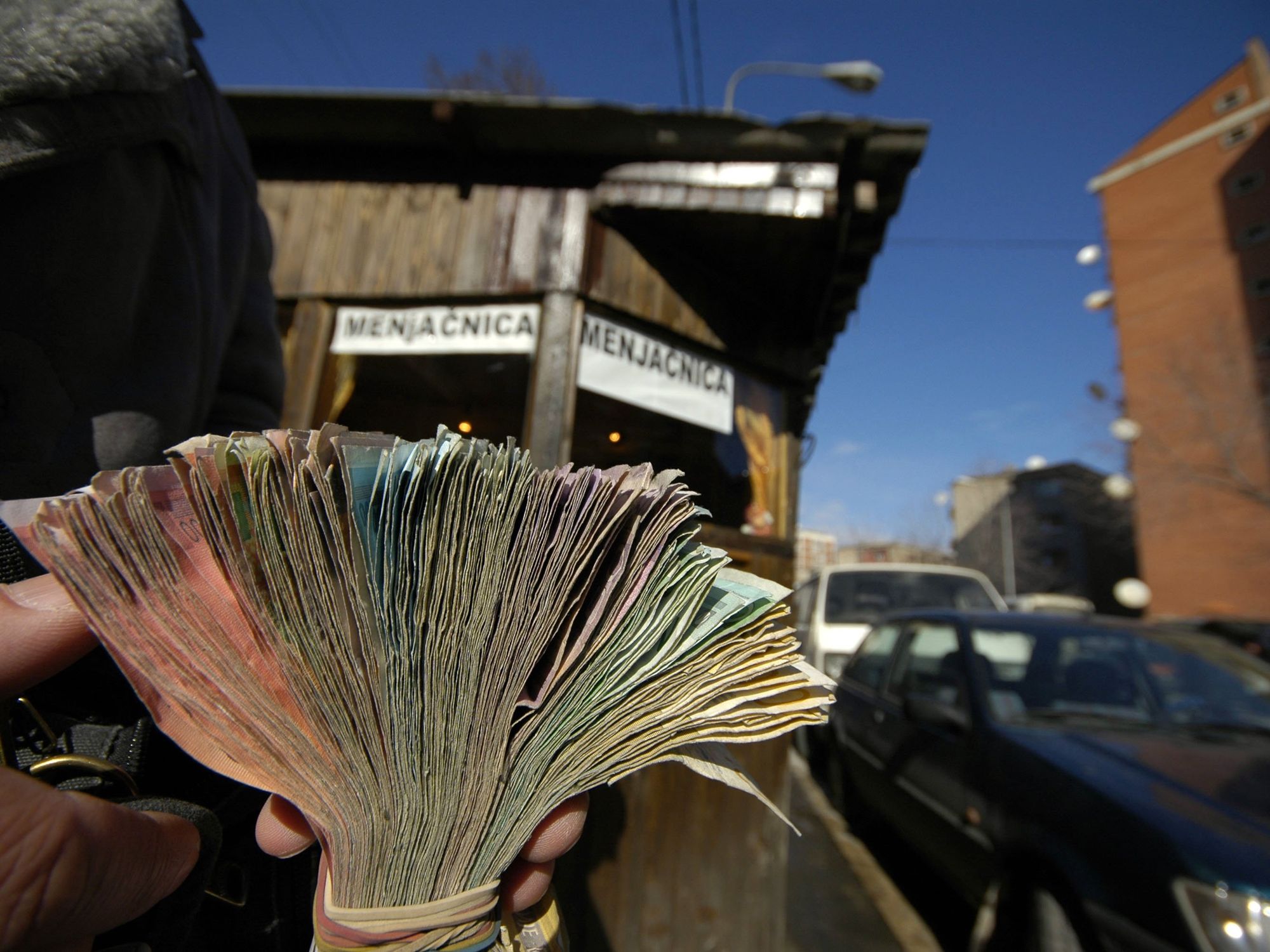 A man's hand counting cash.