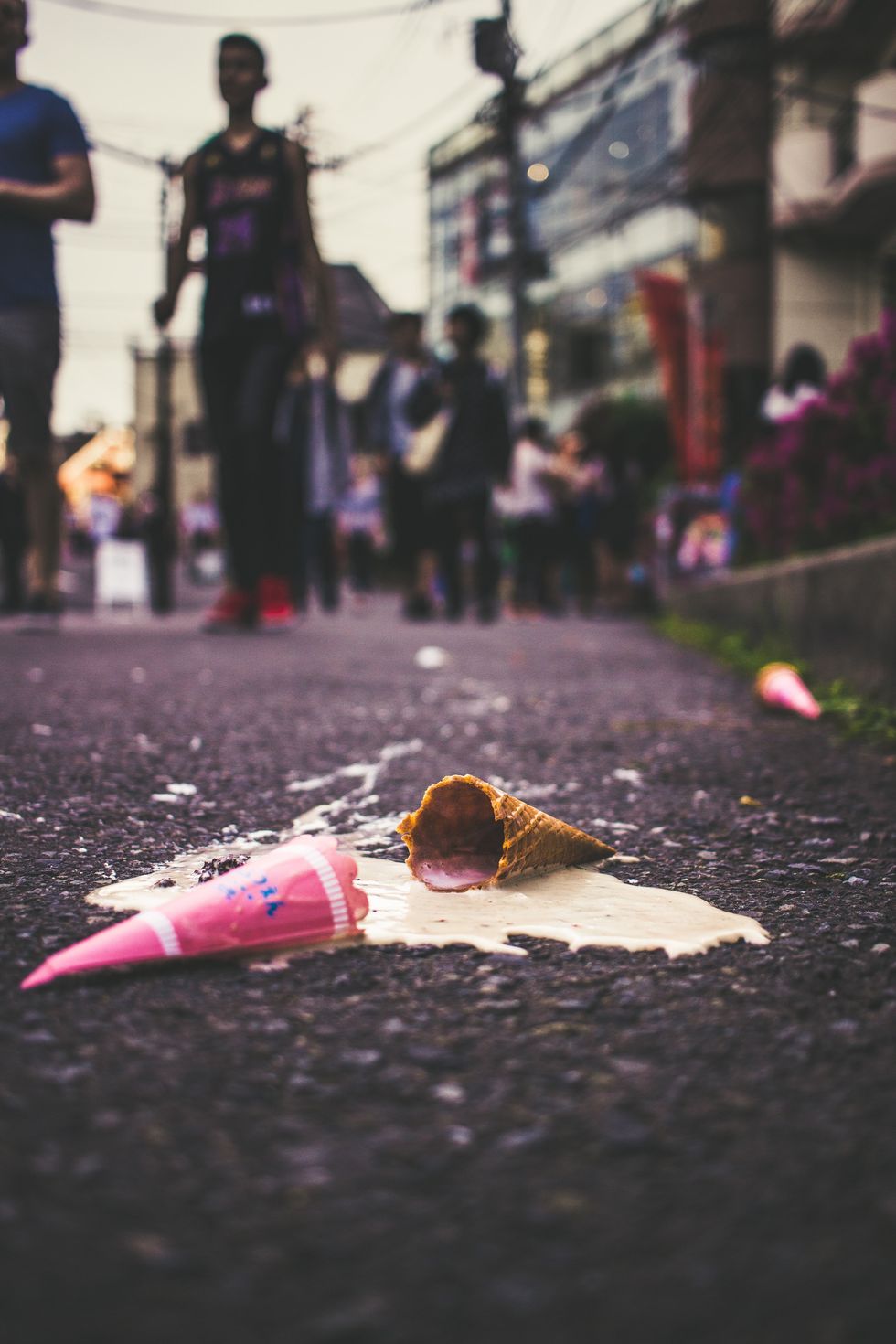 A melted ice cream cone on a road.