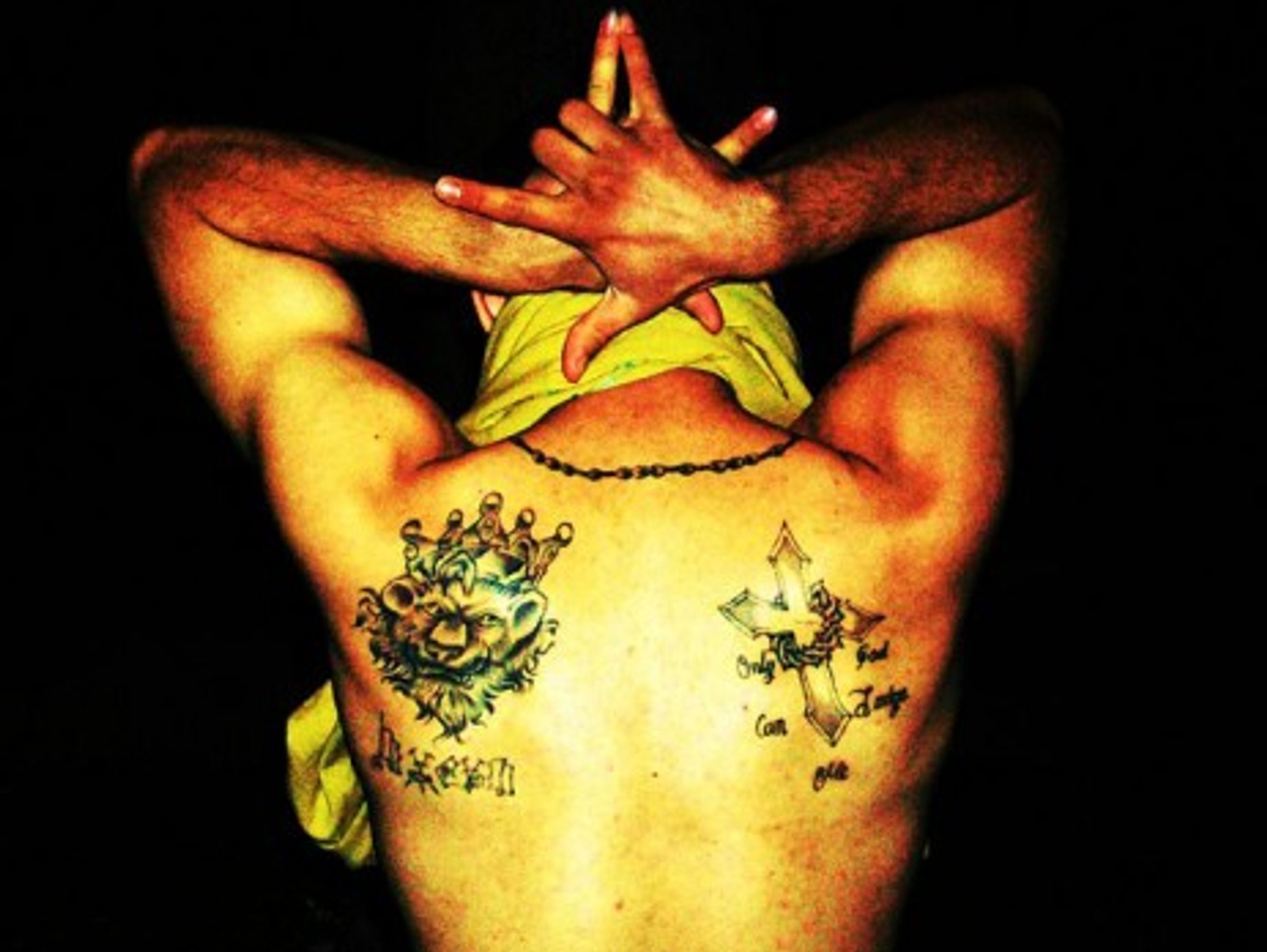 A member of the Latin King gang showing his tattoos (Javier Ramirez)