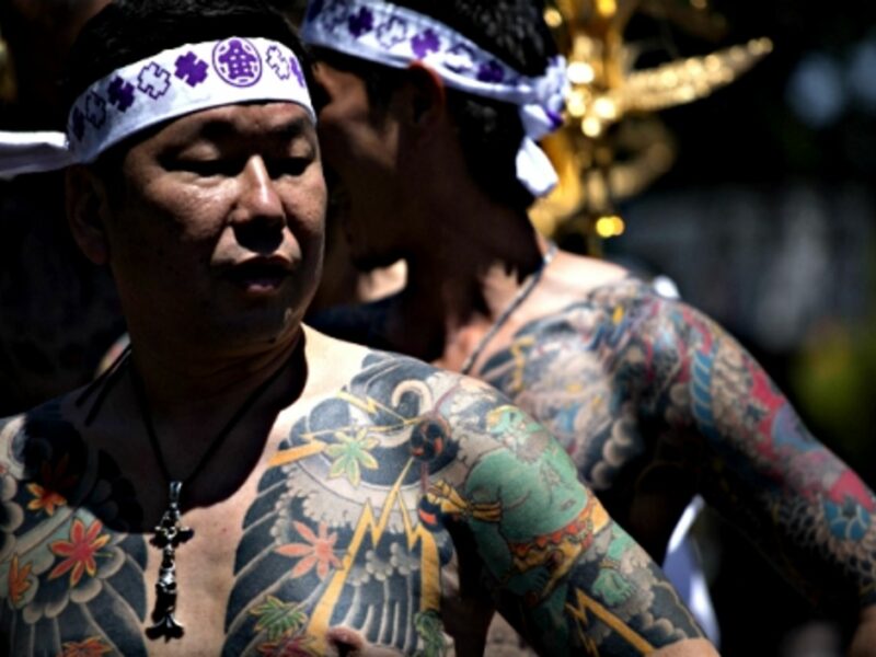 A member of the Yakuza shows off his tattoos during the Sanja Matsuri in Tokyo, 2014.