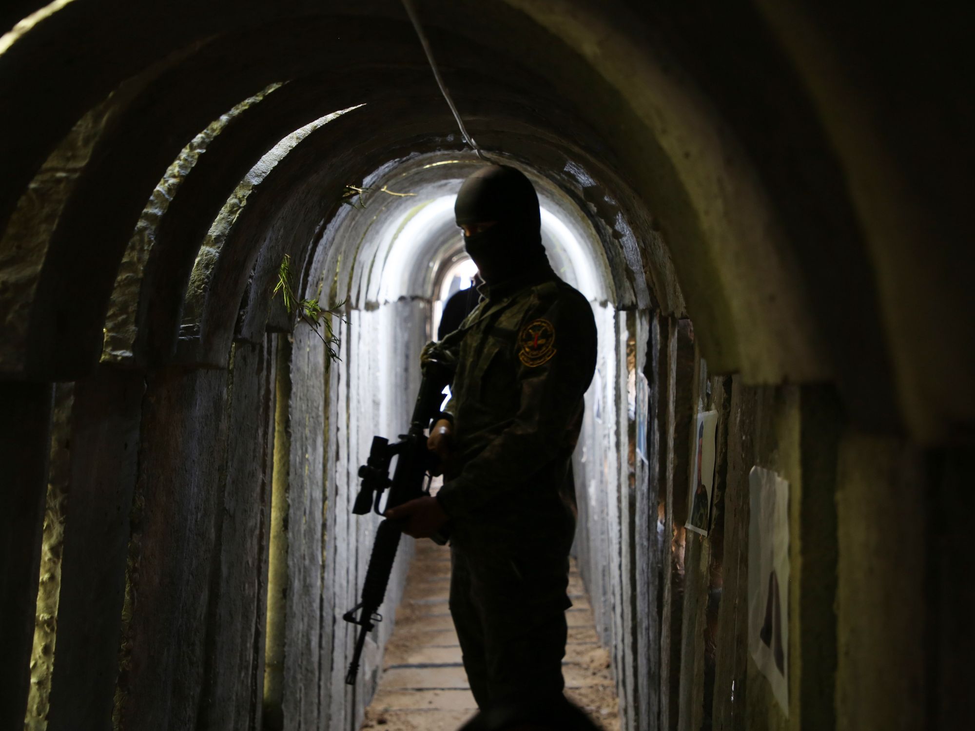A militant stands in a dark underground tunnel