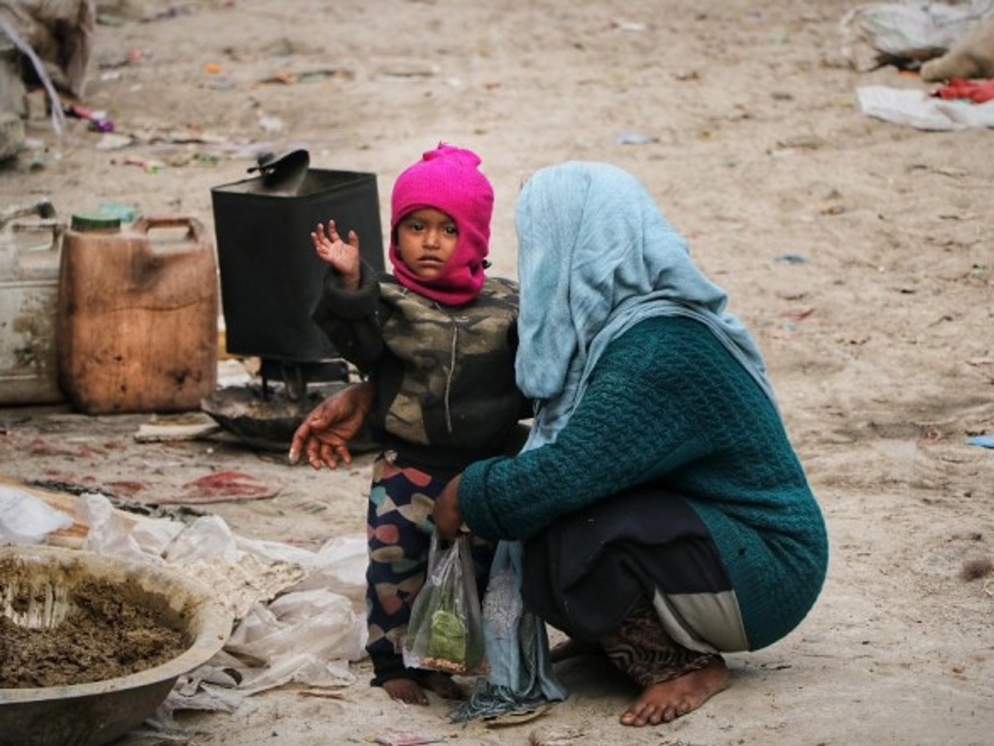 A mother cares for her child on the outskirts of Srinagar city in India