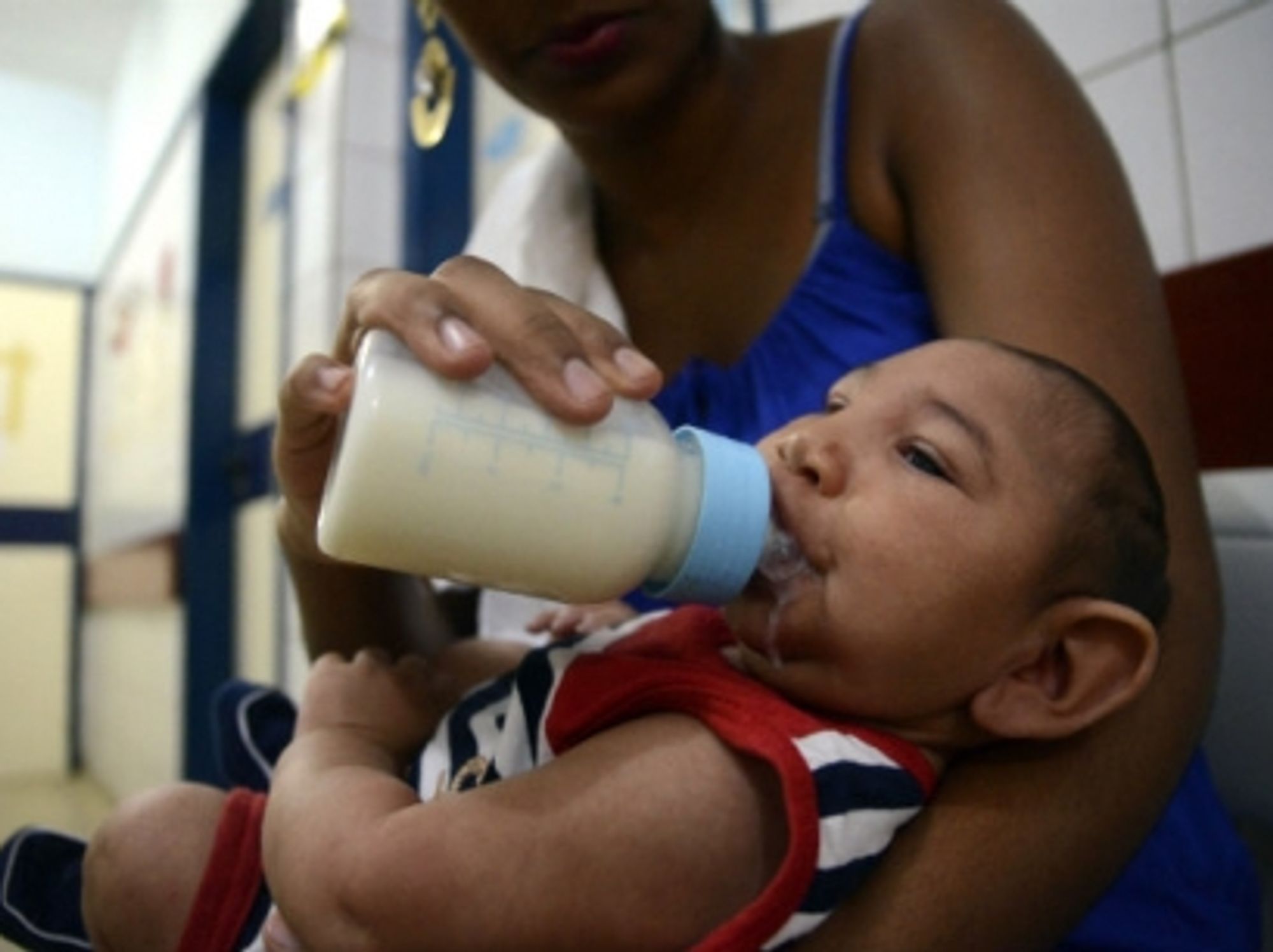 A mother feeds her baby suffering from microcephaly while waiting for examination in Recife, Brazil, on Feb. 2, 2016.