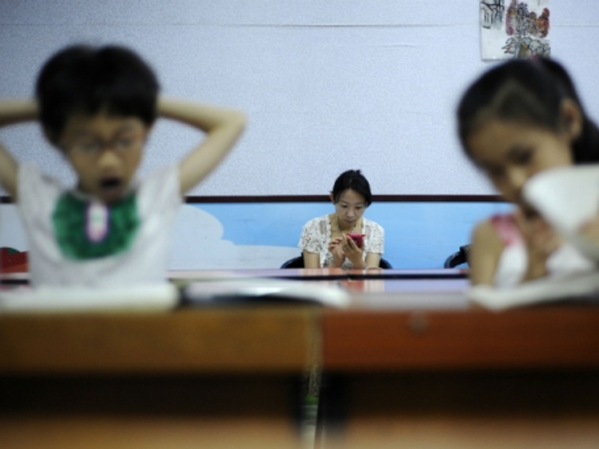 A mother waiting for her children during a music class in Yinchuan