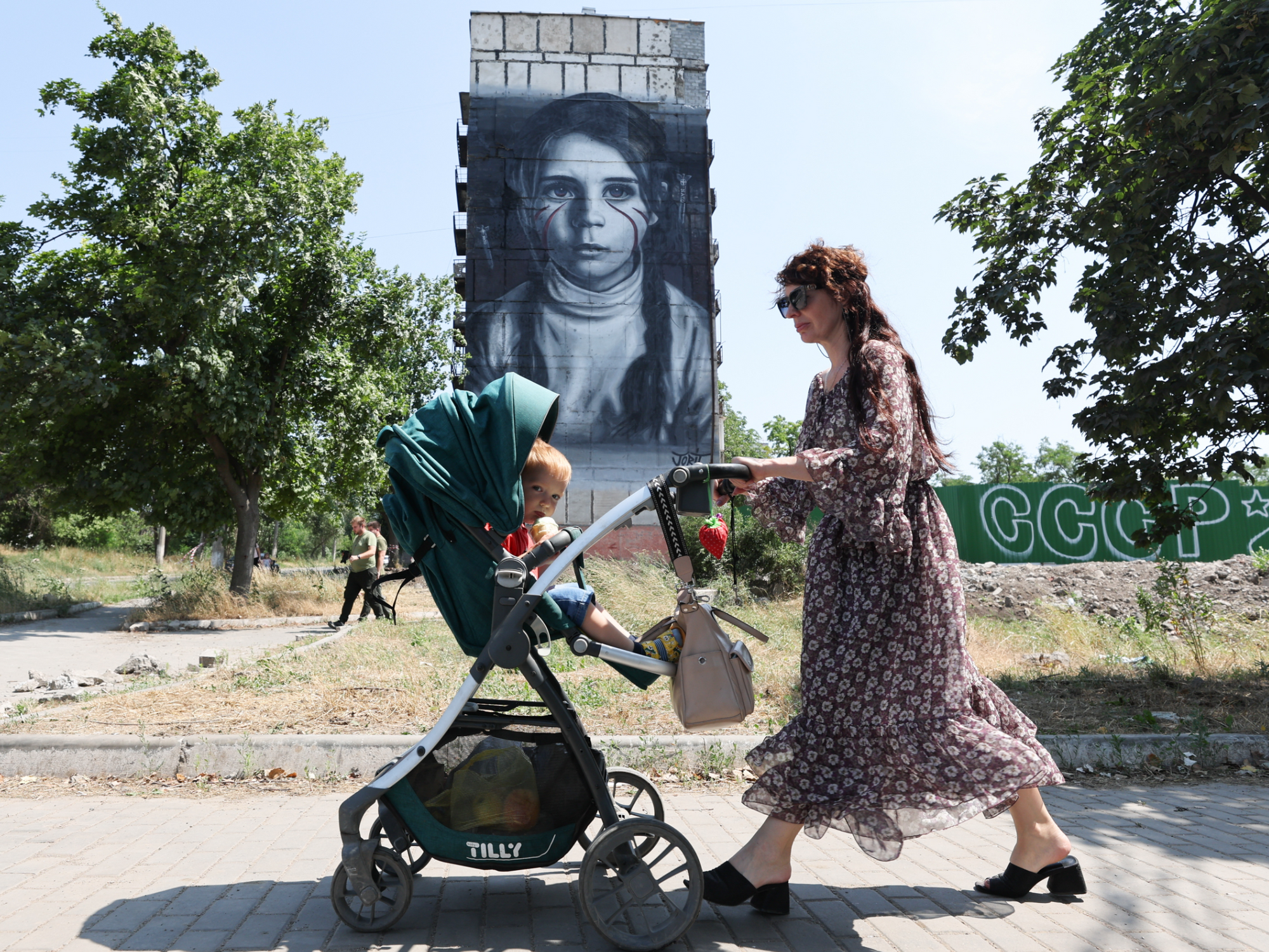 A mural for children of Donbass by Italian street artist Ciro Cerullo aka Jorit stands on Metallurgov Street in Mariupol.