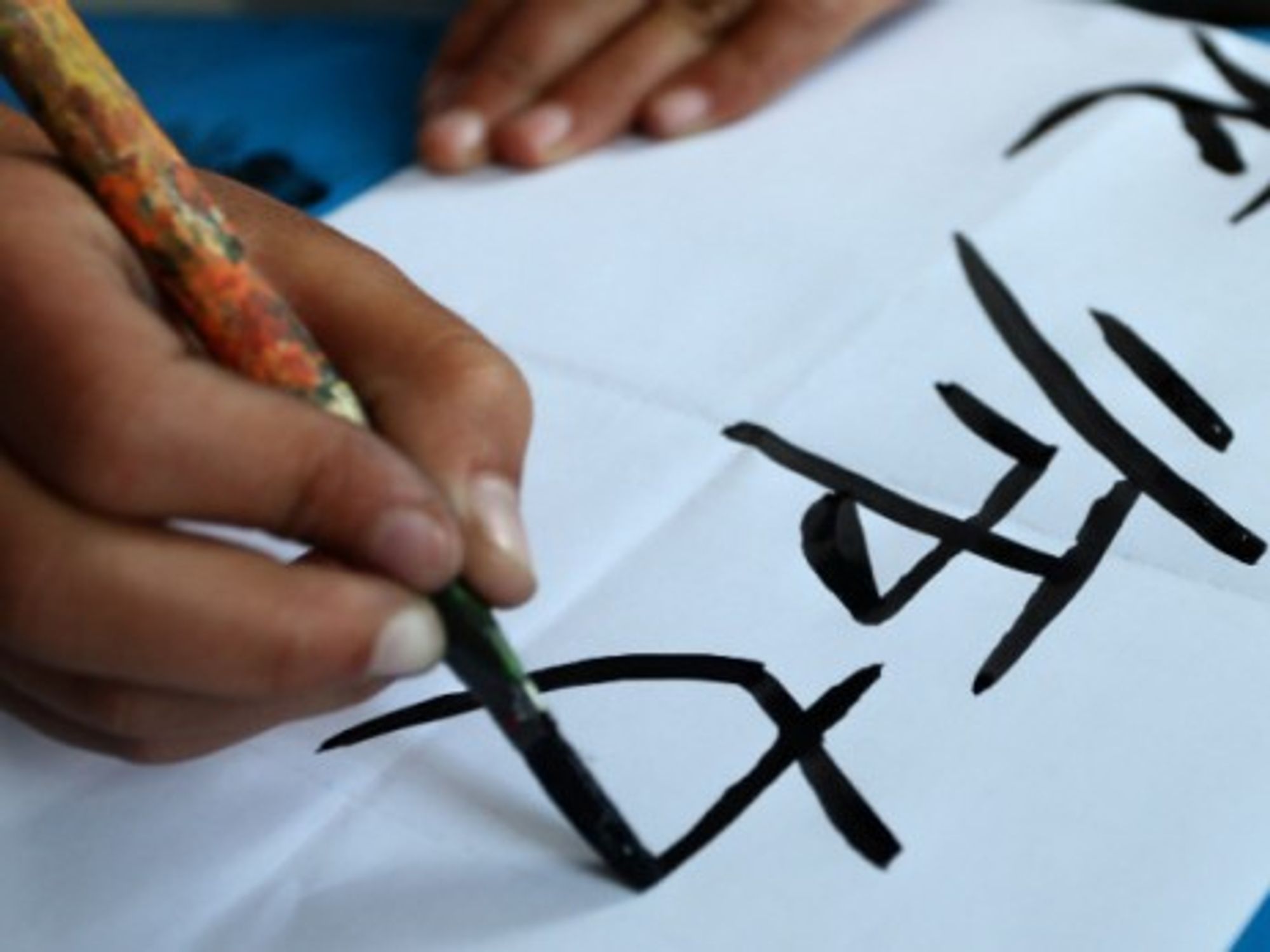 A Nepalese student writes Chinese characters in class in Kathmandu, Nepal, in April 2014.