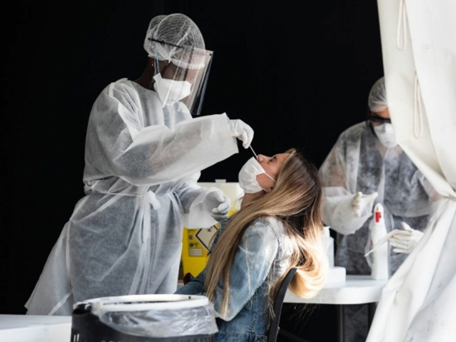A nurse performing a PCR test in Paris