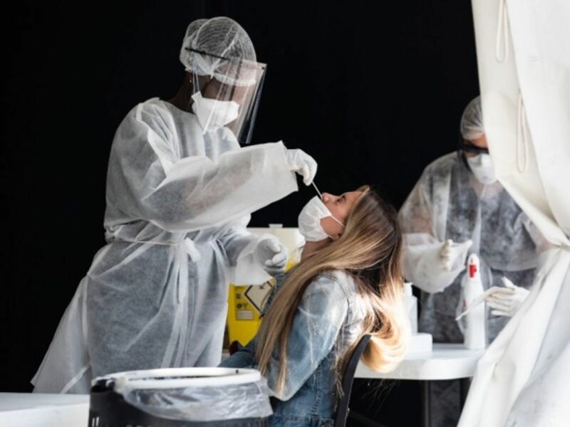 A nurse performing a PCR test in Paris