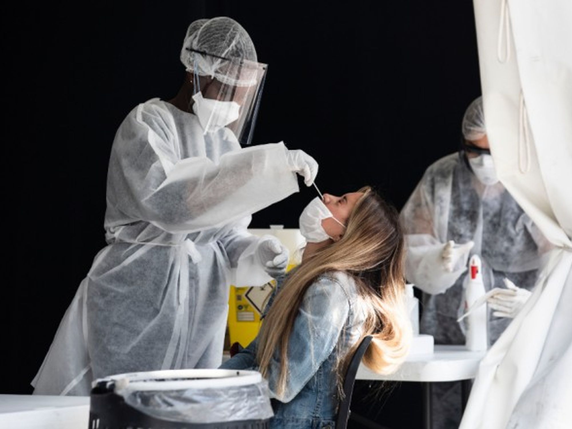 A nurse performing a PCR test in Paris