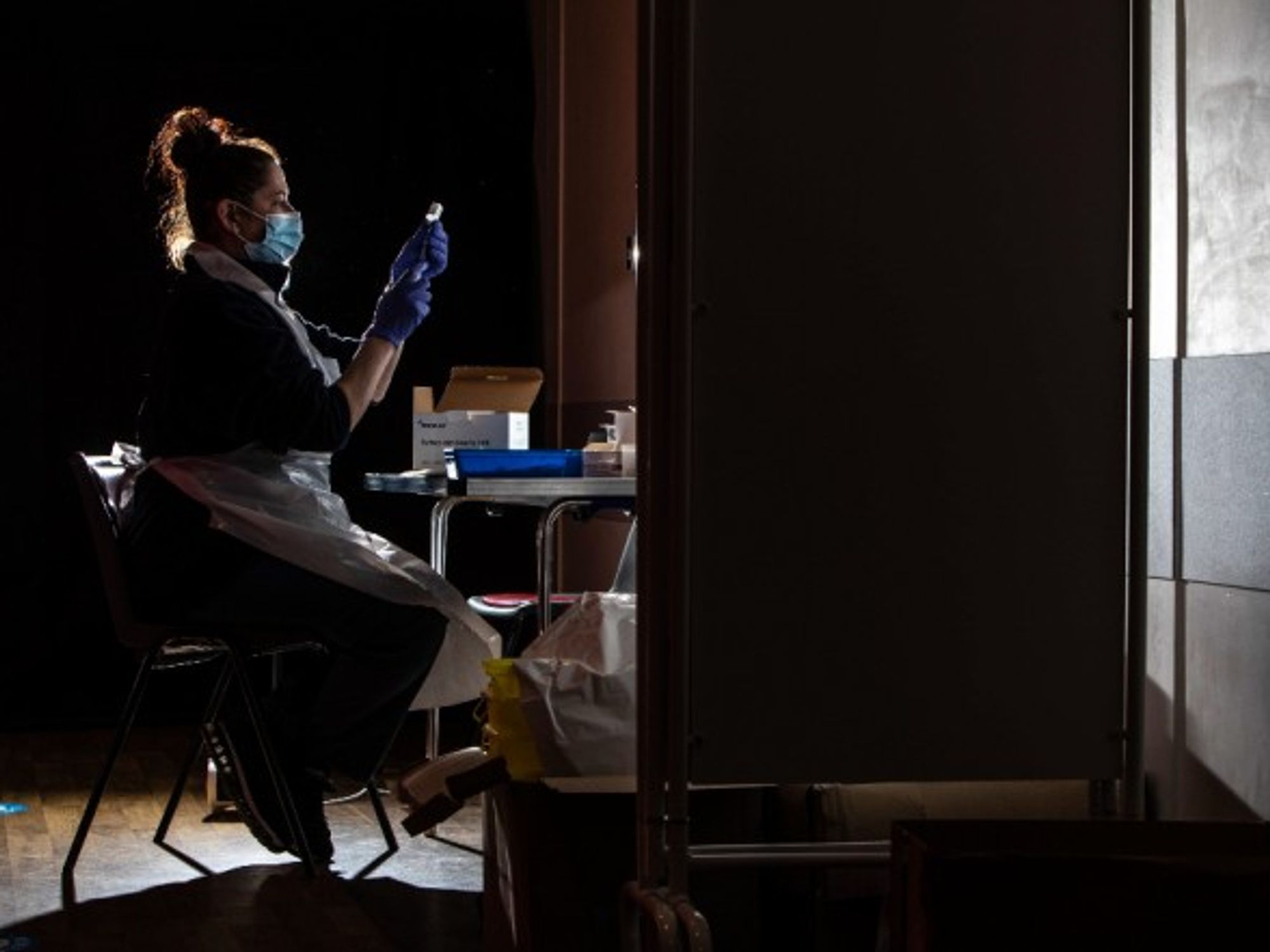 A nurse prepares the COVID-19 Oxford/AstraZeneca vaccine in the UK