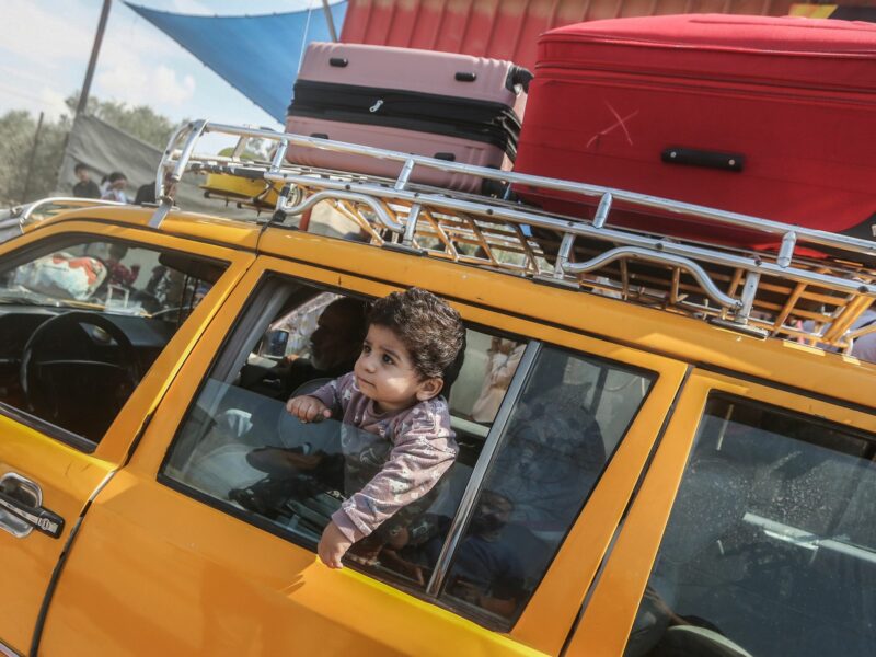A Palestinian child peeks out of a car window at the Rafah border crossing in the southern Gaza Strip.