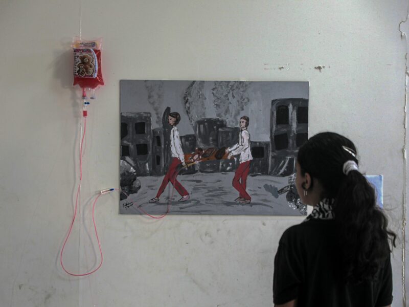 A Palestinian girl views an artwork at a World Mental Health Day exhibition in the southern Gaza Strip city of Khan Younis, on Oct. 10, 2024.