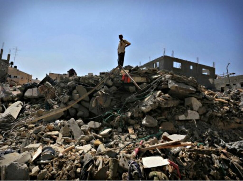 A Palestinian man stands amid ruins in Beit Hanoun in the northern Gaza Strip