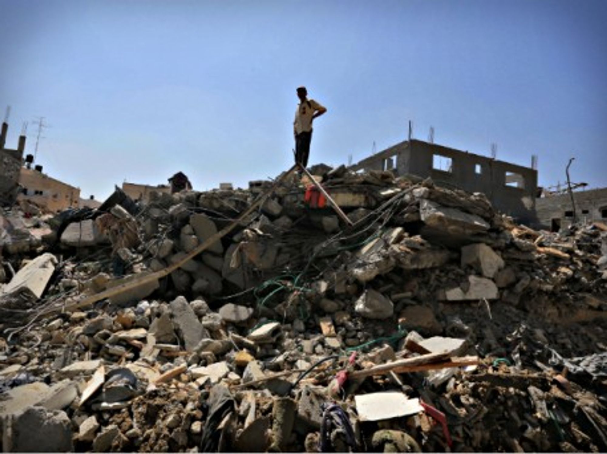 A Palestinian man stands amid ruins in Beit Hanoun in the northern Gaza Strip
