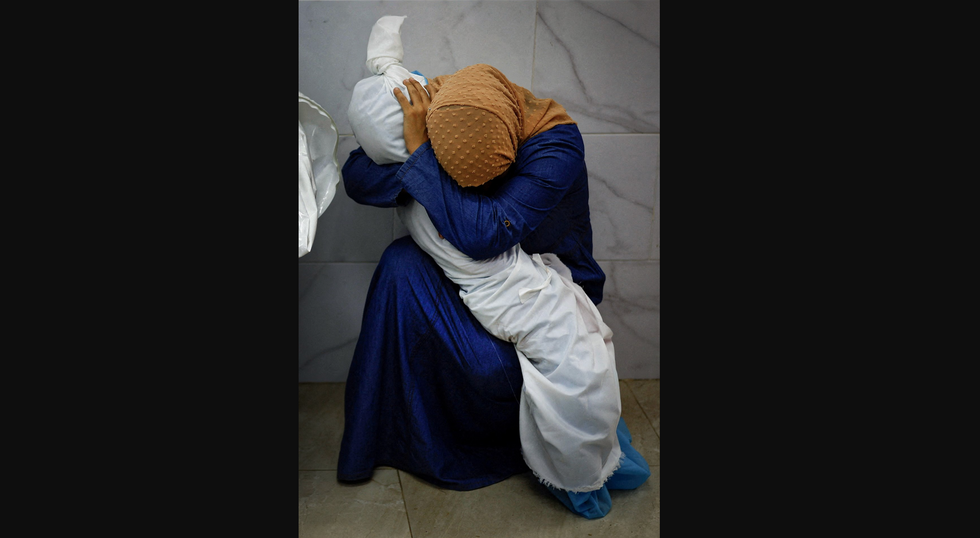 "A Palestinian Woman Embraces the Body of Her Niece" by Mohammed Salem