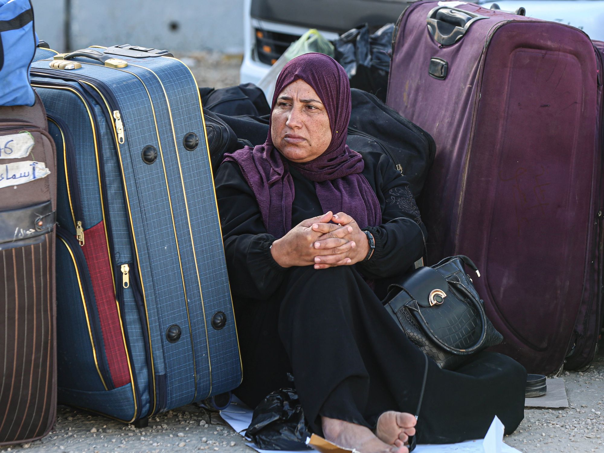 A Palestinian woman waits to cross into Gaza from the Egyptian side of the Rafah crossing.