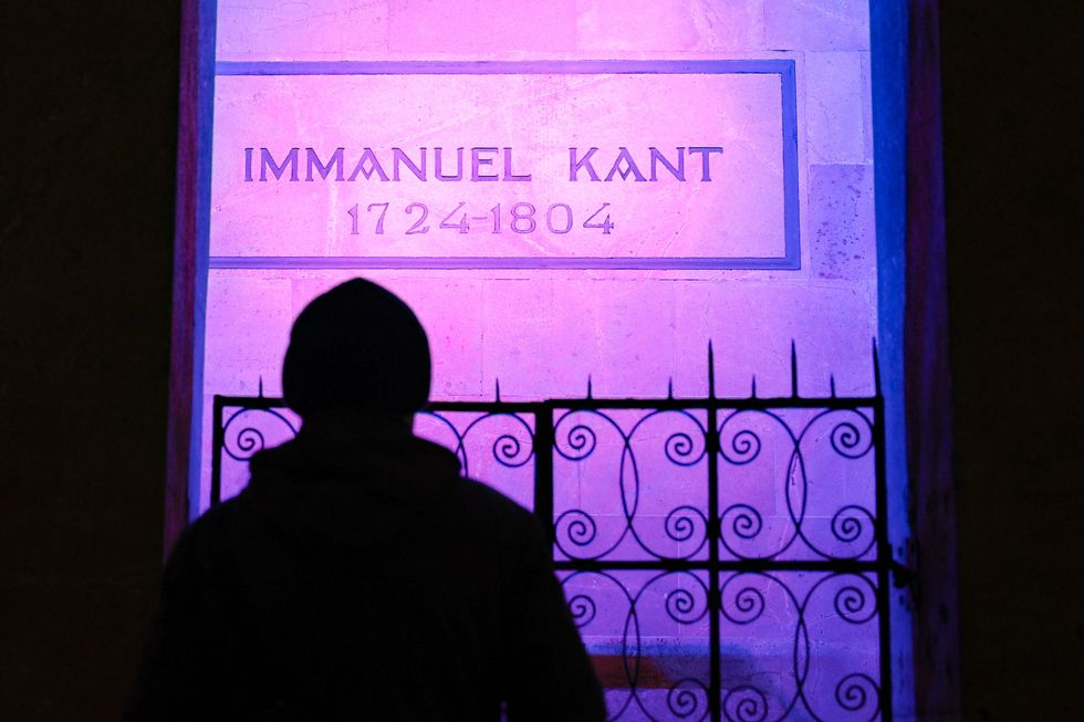 A person is seen at Immanuel Kant's Tomb at the Konigsberg Cathedral.