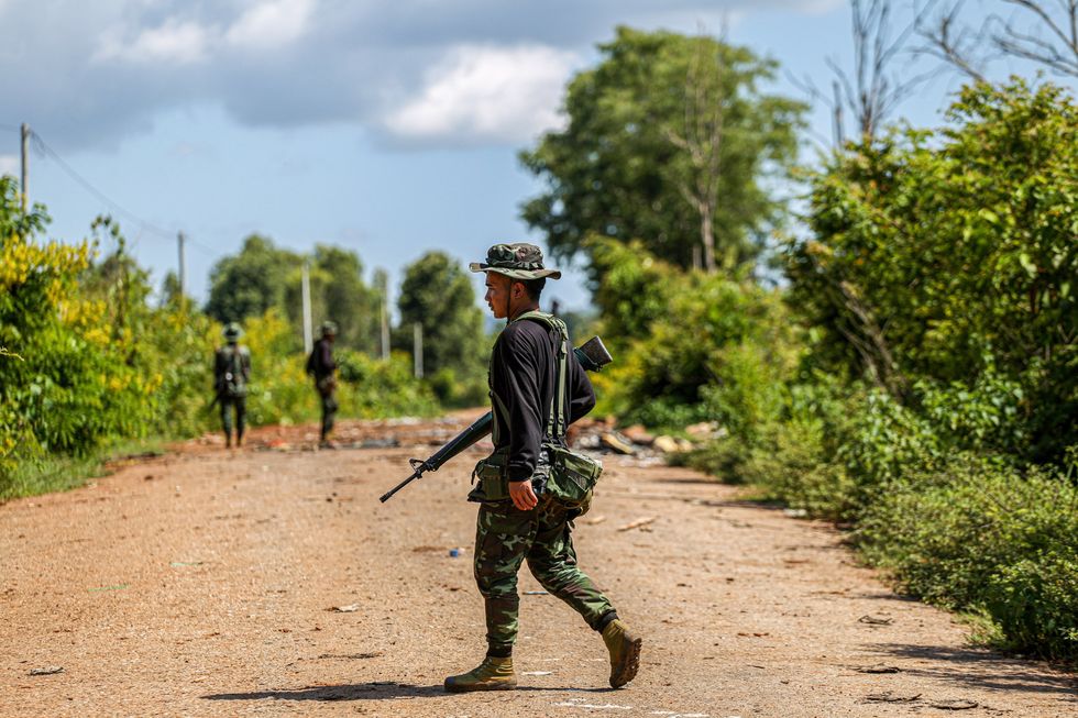 A photo A soldier in Myanmar patrolling the street.