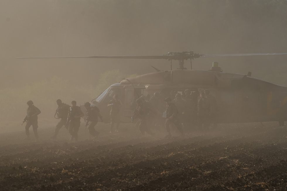A photo injured Israeli soldiers are transfered to a helicopter near the Israeli northern border with Lebanon, on Sept. 19, 2024.