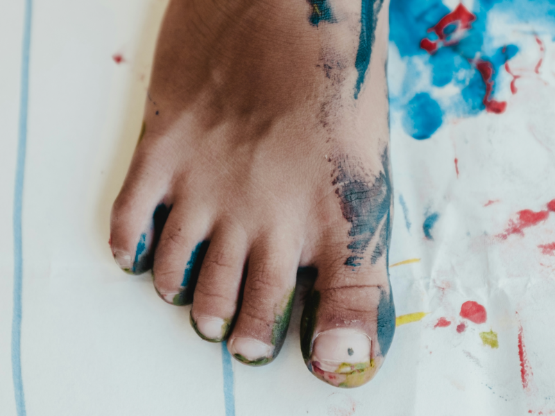 A photo of a child's foot that was dipped in paint placed on a piece of paper to leave an imprint