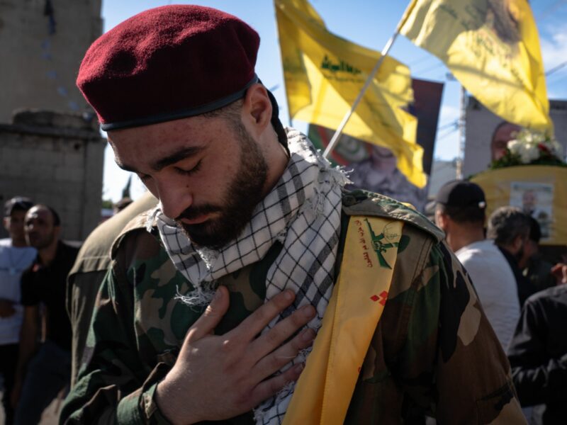 A photo of a Hezbollah fighter mourns during the funeral of another Hezbollah fighter.