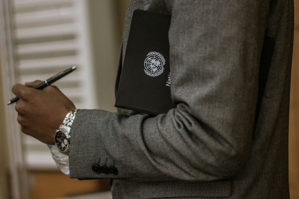A photo of A man holding a United Nations booklet.