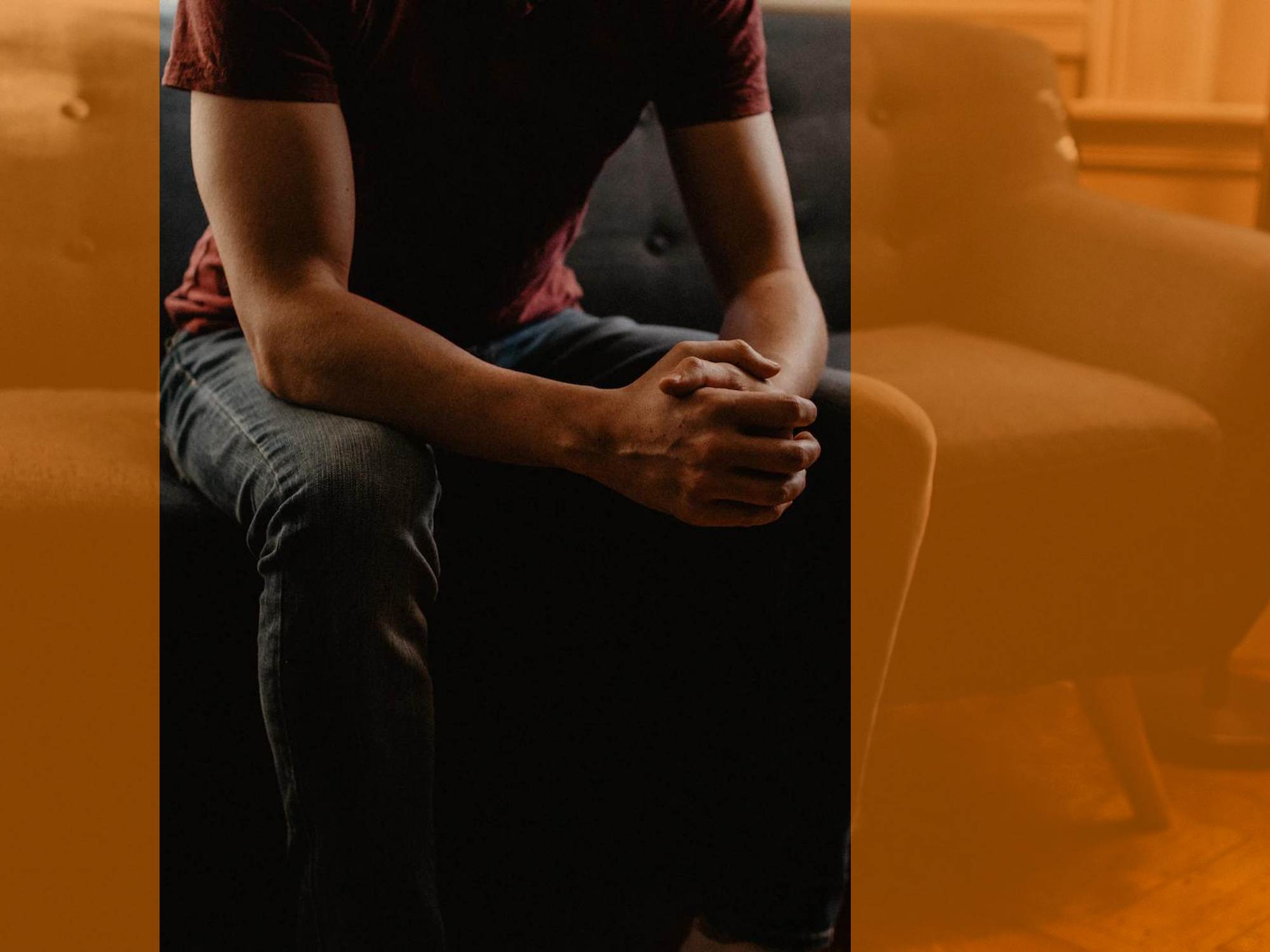 A photo of a man sitting on a couch during therapy session
