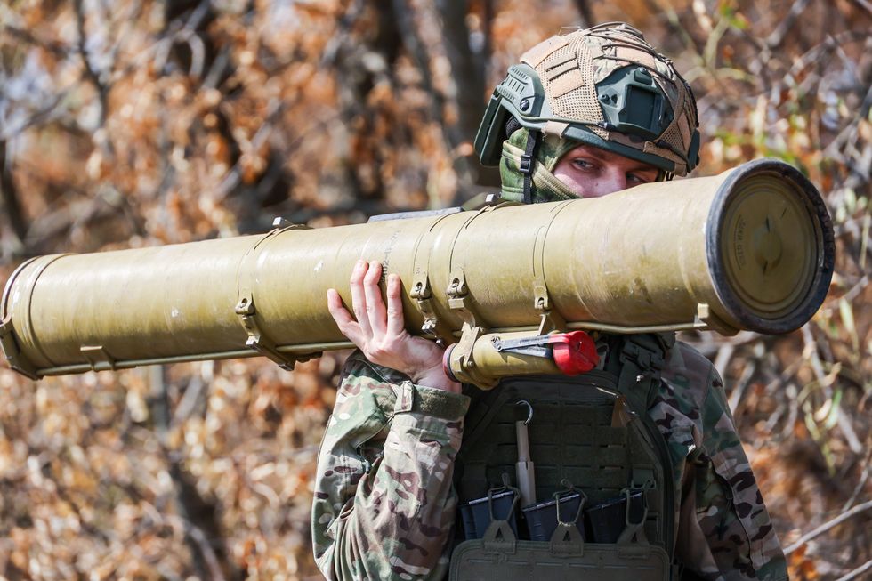 A photo of a Russian soldier carrying an anti-tank missile launcher.