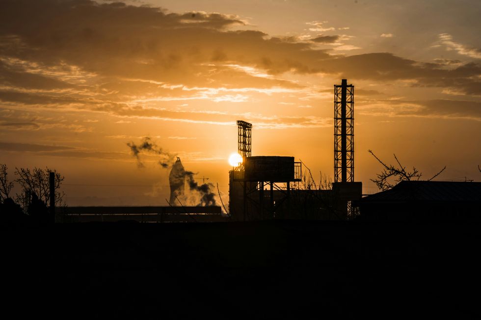 A photo of a sunset view from the industrial part of the city