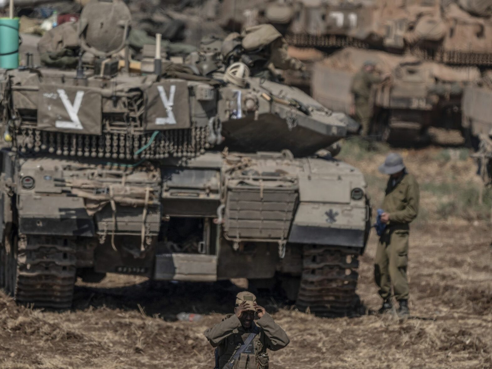 A photo of Israeli military tanks gather by the Israeli-Lebanon border.