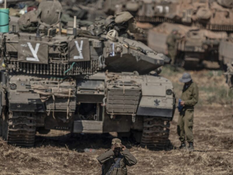 A photo of Israeli military tanks gather by the Israeli-Lebanon border.