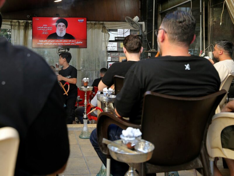A photo of Lebanese supporters watching TV.