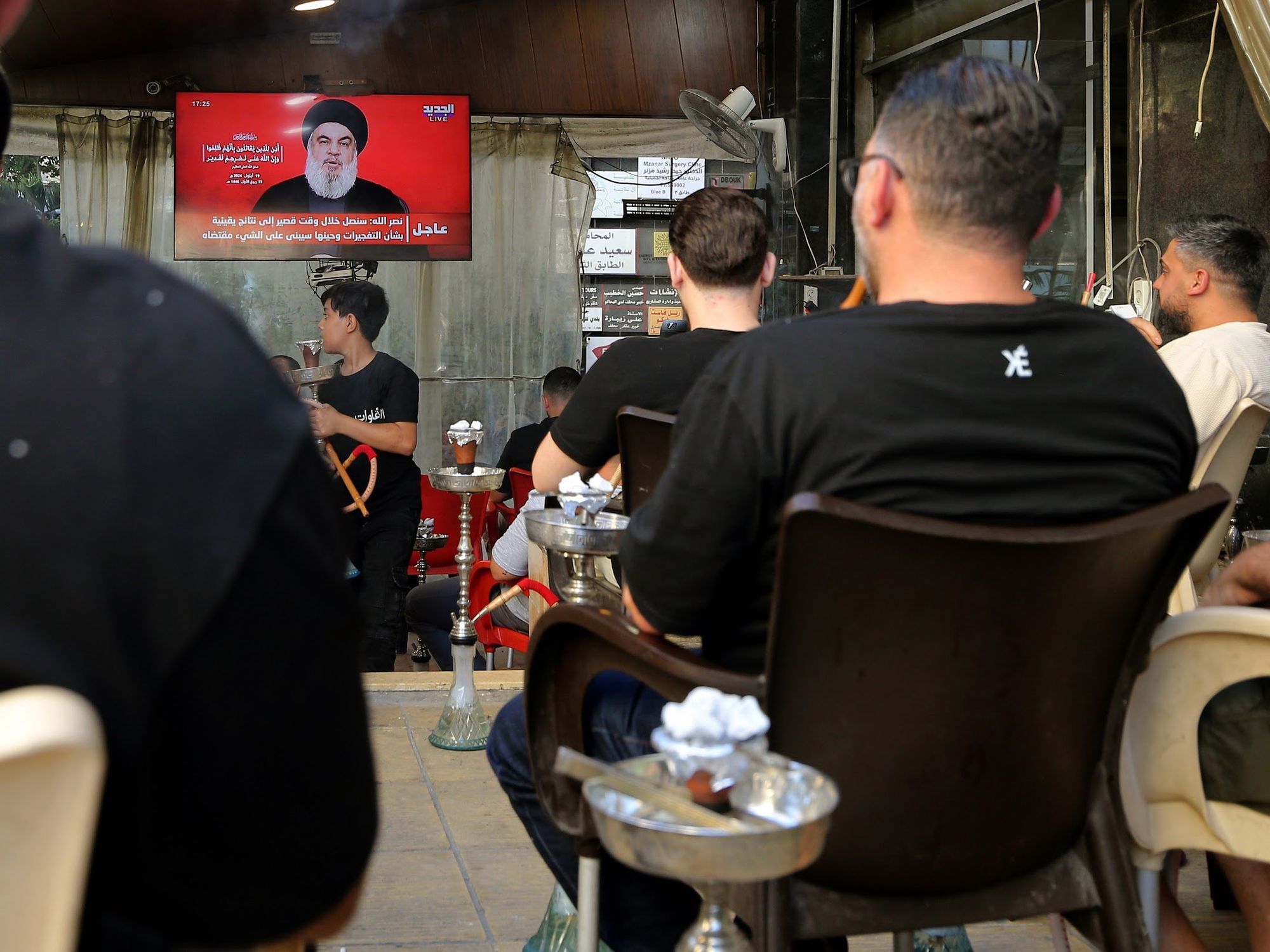 A photo of Lebanese supporters watching TV.