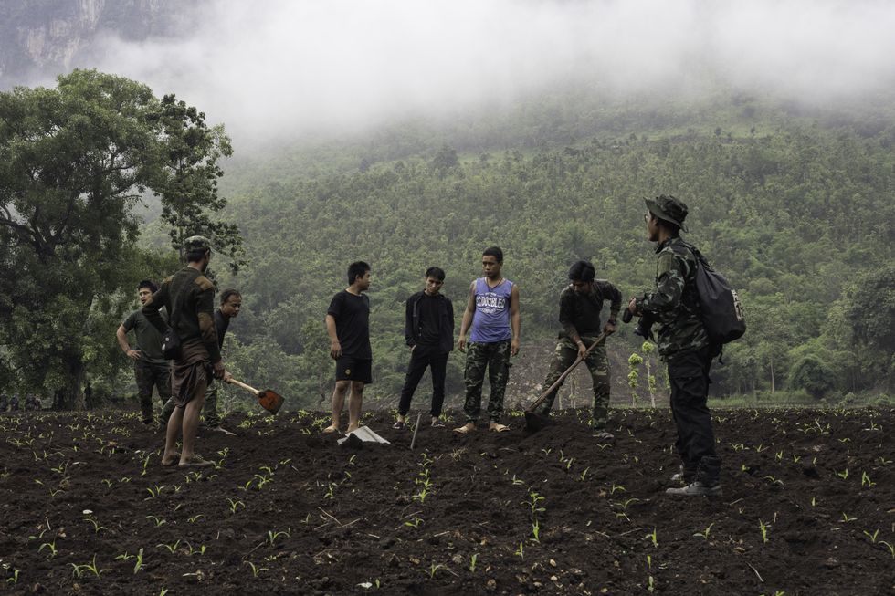 A photo of National Defense Force-KNDF members retrieving an unexploded air bomb in.