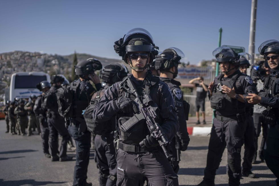 A photo of Police officers stand guard as Israeli Arabs and left-wing Israelis take part in a protest against the war in Gaza and the escalation in Lebanon and Iran.