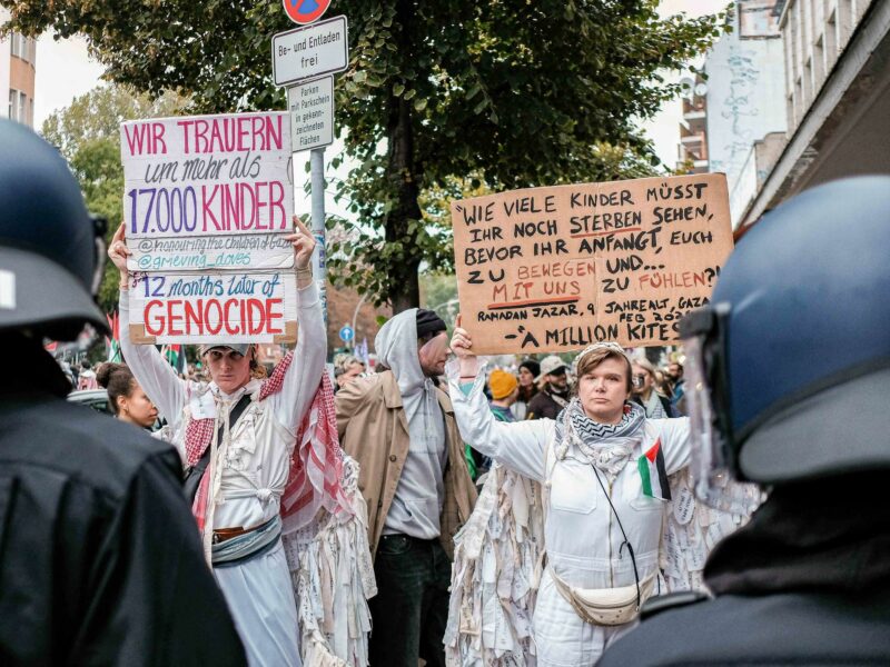 A photo of protesters marching to show solidarity with palestinians in Gaza.