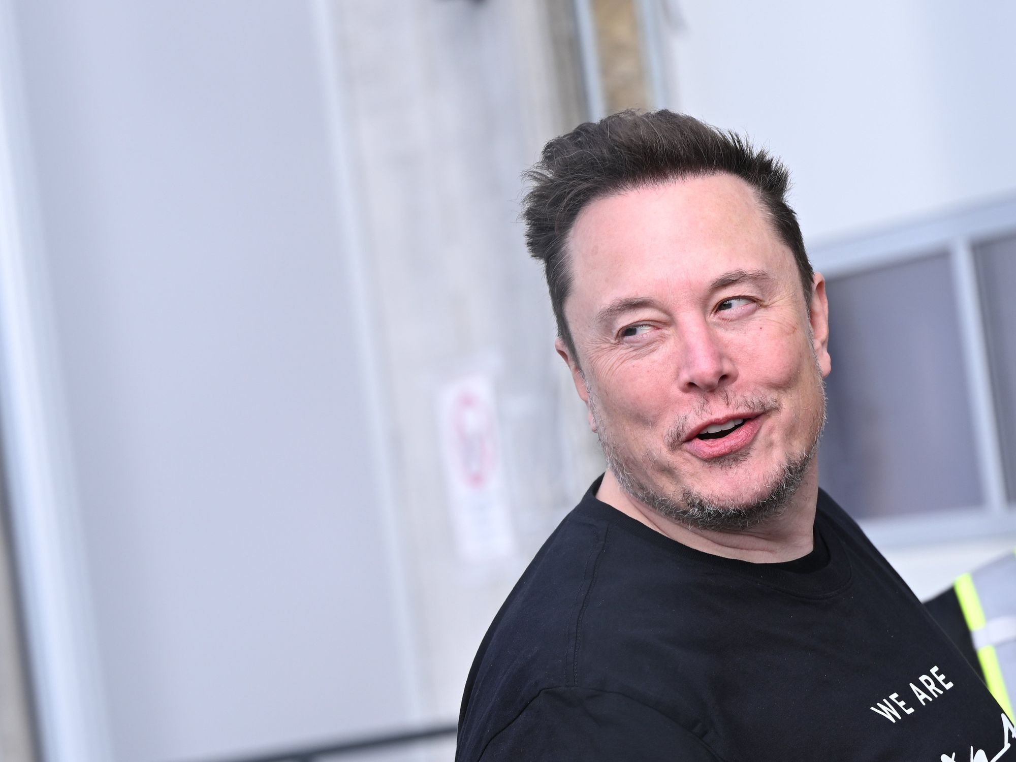 A photo of Tesla CEO Elon Musk walking through the Tesla Gigafactory in Berlin, Germany.