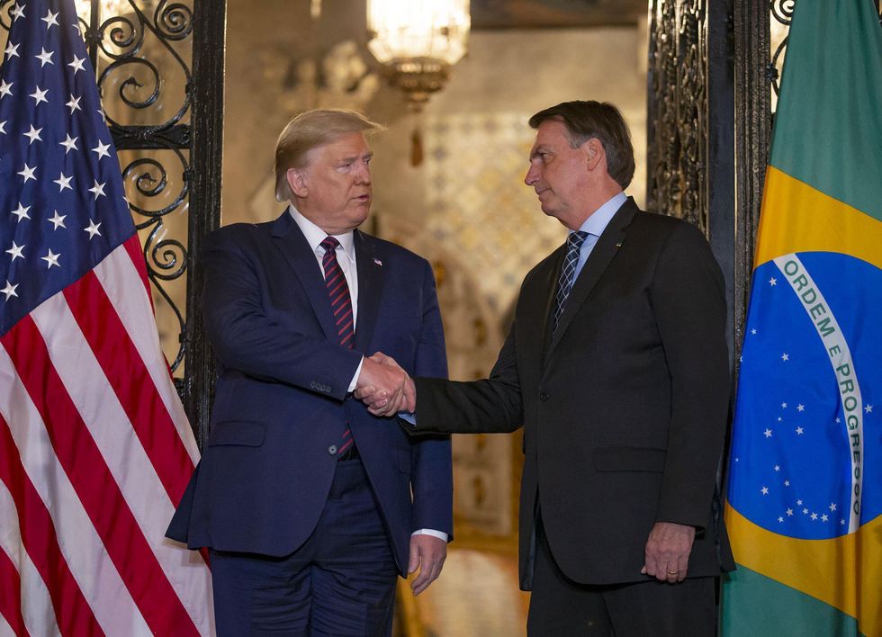 A photo of then President Donald Trump with Brazilian President Jair Bolsonaro shaking hands at Mar-a-Lago in Palm Beach.