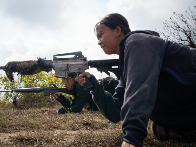 A photo of Two service women seen training with their guns during a military training