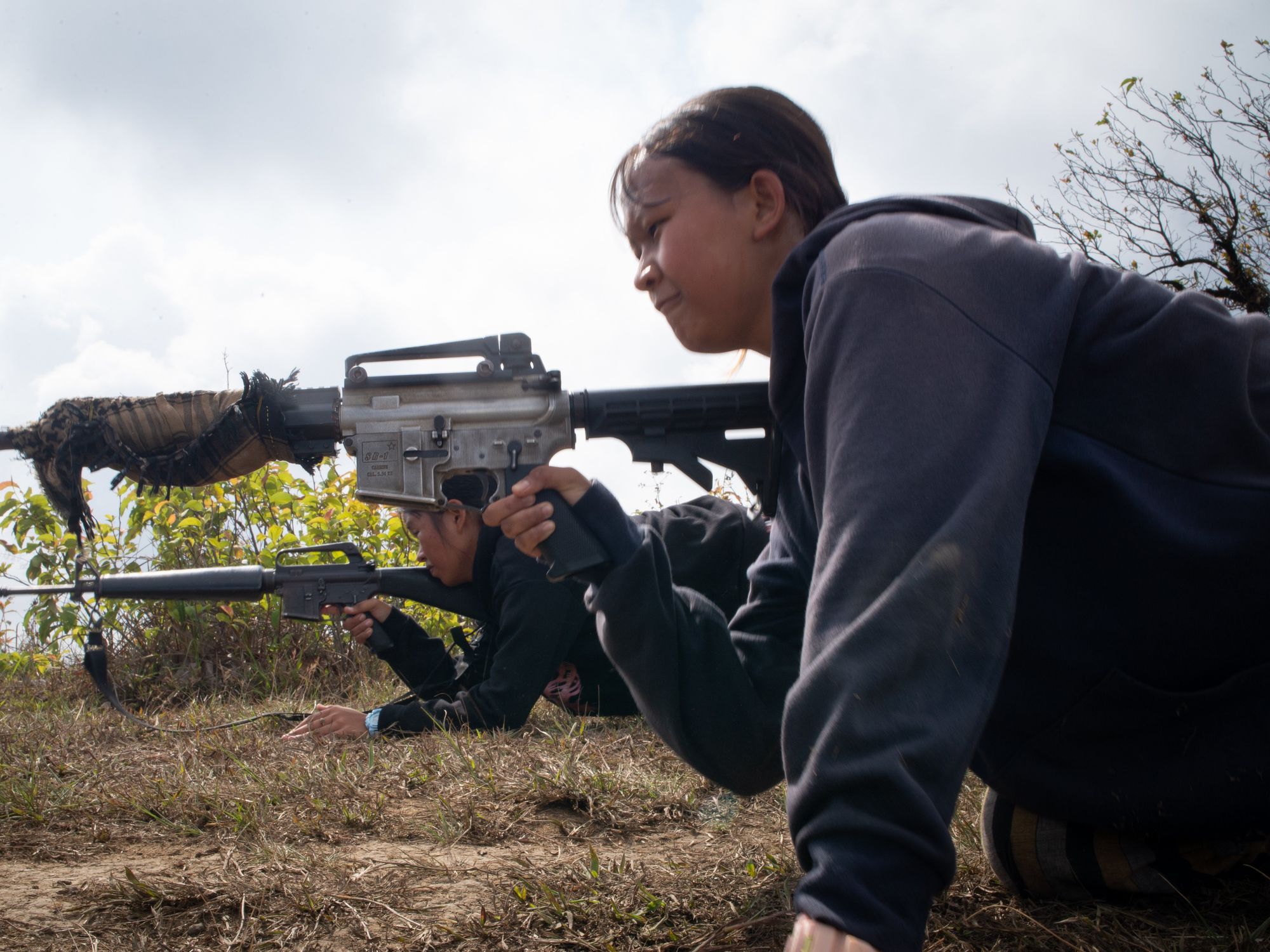 A photo of Two service women seen training with their guns during a military training