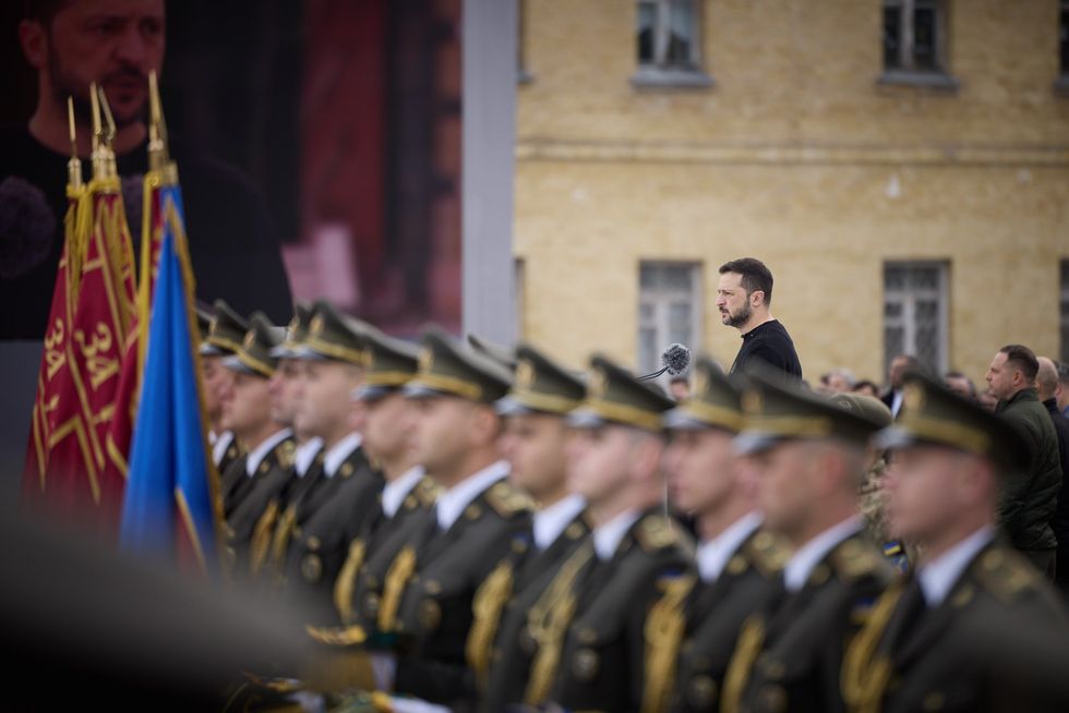A photo of Vladimir Zelenskiy giving a speech at a military event.