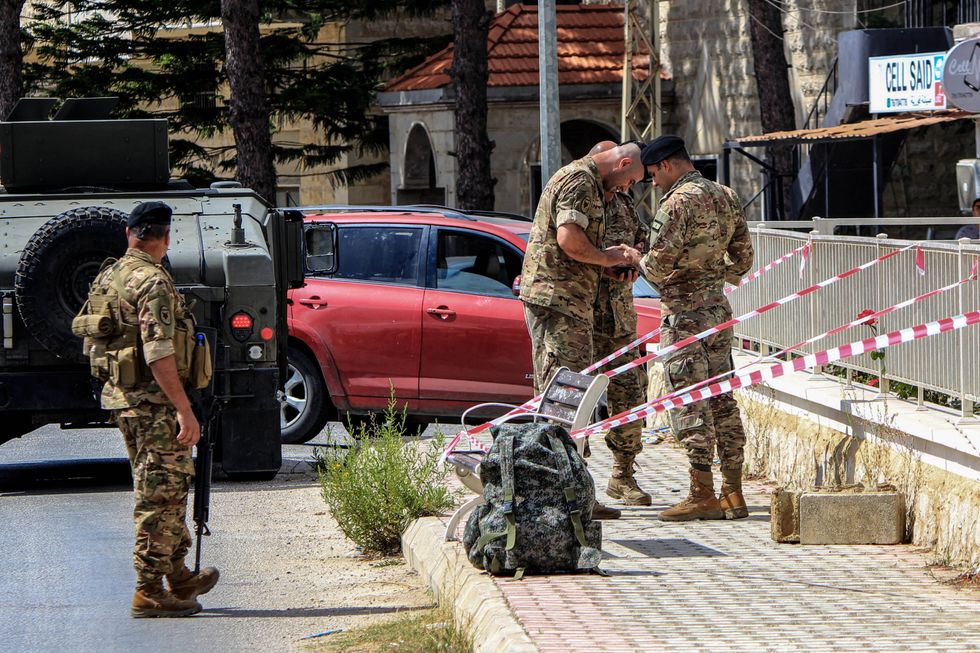 A photo ofLebanese army explosives experts work on preparing the site to explode a walkie- talkie that they found discarded a day after several devises exploded killing pro-Iranian Hezbollah militants.