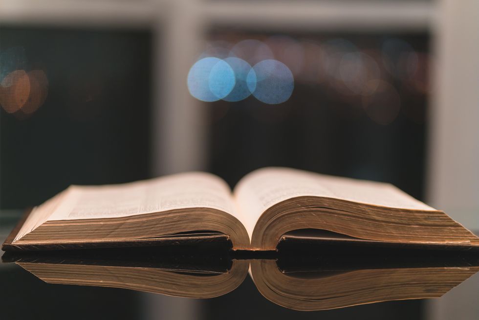 A photograph of an old book open on a table