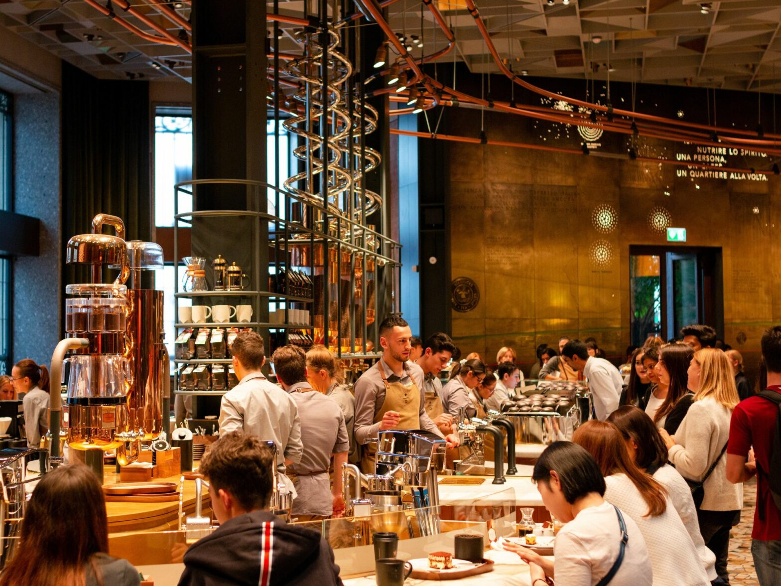 A photograph of customers and staff inside of the Starbucks Reserve Roastery in Milan