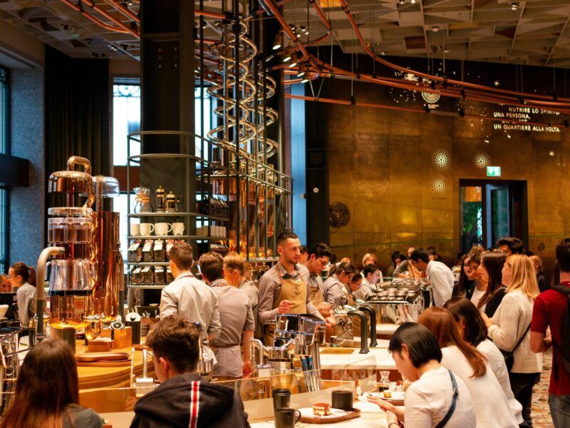 A photograph of customers and staff inside of the Starbucks Reserve Roastery in Milan