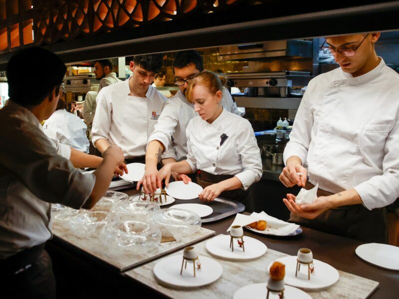 A photograph of ​workers at the Disfrutar restaurant in Barcelona, Spain, preparing dishes.