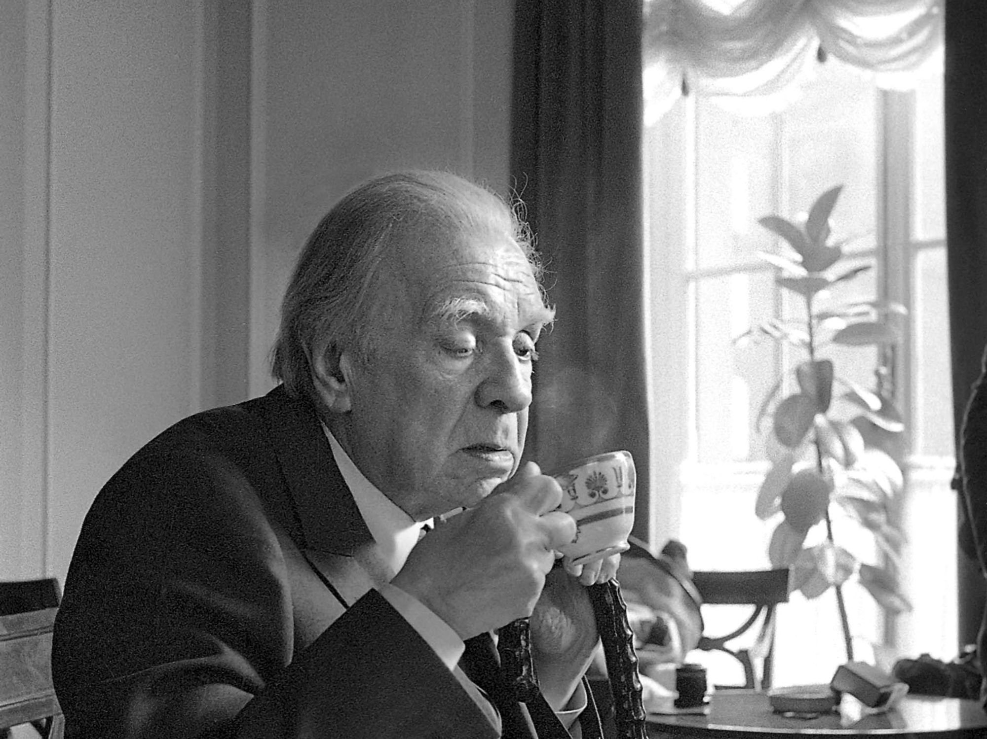 A picture shows Argentinian writer Jorge Luis Borges in Via Veneto, Rome, Italy. He is drinking from a coffee cup.